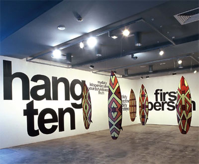 Vernon Ah Kee: Cant chant (Wegrewhere), 2007 – 2009, video, painted surfboards and vinyl lettering, installation view, IMA Brisbane; photo Richard Stringer; courtesy the artist/ Milani Gallery